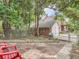 Landscaped backyard with patio, lush greenery, and a detached garage at 2303-2305 W 32Nd Ave, Denver, CO 80211