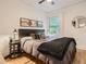 Bedroom with wood floors, black headboard, and a comfy blanket on the bed by a sunlit window at 2303-2305 W 32Nd Ave, Denver, CO 80211