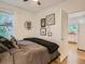 Bright bedroom with wood floors, comfortable bedding, and an open doorway view into the kitchen at 2303-2305 W 32Nd Ave, Denver, CO 80211