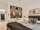 Well-lit bedroom featuring hardwood floors, a zebra art piece, and cozy bedding with a knitted blanket at 2303-2305 W 32Nd Ave, Denver, CO 80211