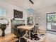 Elegant dining room featuring a sleek table, decorative fireplace, and hardwood floors at 2303-2305 W 32Nd Ave, Denver, CO 80211