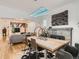 Stylish dining room with a modern light fixture, stone fireplace, and open layout to the living area at 2303-2305 W 32Nd Ave, Denver, CO 80211