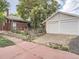 Exterior of the property with a detached two-car garage and patio at 2303-2305 W 32Nd Ave, Denver, CO 80211