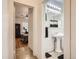 Hallway view of a bright bedroom and half bath, highlighting the home's functional layout at 2303-2305 W 32Nd Ave, Denver, CO 80211