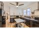 Kitchen with white upper cabinets, dark lower cabinets, and stainless steel countertops at 2303-2305 W 32Nd Ave, Denver, CO 80211