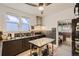 Kitchen with dark cabinets, stainless steel island, and open doorway at 2303-2305 W 32Nd Ave, Denver, CO 80211