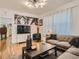 Comfortable living room with stylish decor, a modern TV, and plenty of seating for entertaining at 2303-2305 W 32Nd Ave, Denver, CO 80211
