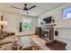 Comfortable living room with a brick fireplace, hardwood floors, and ample natural light at 2303-2305 W 32Nd Ave, Denver, CO 80211