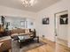 Spacious living room with hardwood floors, contemporary furniture, and an open layout to the dining area at 2303-2305 W 32Nd Ave, Denver, CO 80211
