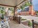 Charming porch with brick detail and seating, offering a view of the street and surrounding neighborhood at 2303-2305 W 32Nd Ave, Denver, CO 80211