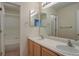 Bright bathroom featuring a double vanity, mirror and separate shower room at 10272 Fawnbrook Ct, Highlands Ranch, CO 80130