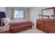 Cozy bedroom featuring a comfortable bed and a wooden dresser at 10272 Fawnbrook Ct, Highlands Ranch, CO 80130