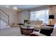 Bright living room featuring neutral décor, large window and staircase at 10272 Fawnbrook Ct, Highlands Ranch, CO 80130