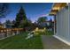 Landscaped backyard with Adirondack chairs and string lights along the fence at 7065 E Caley Ave, Centennial, CO 80111