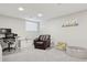 Finished basement with modern desk and chair, comfortable seating, and play area at 7065 E Caley Ave, Centennial, CO 80111