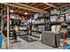 Organized storage room with ample shelving, work-out equipment and TV at 7065 E Caley Ave, Centennial, CO 80111