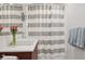 Bright bathroom featuring a modern vanity, vessel sink, and stylish striped shower curtain at 7065 E Caley Ave, Centennial, CO 80111