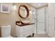 Charming bathroom featuring a unique wooden framed mirror and glass enclosed shower at 7065 E Caley Ave, Centennial, CO 80111