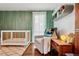 Beautiful Bedroom with modern crib, sage green accent wall, and lovely decor at 7065 E Caley Ave, Centennial, CO 80111