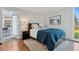Cozy bedroom featuring hardwood floors, a comfortable bed, and access to an outdoor patio at 7065 E Caley Ave, Centennial, CO 80111