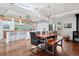Dining room features a modern chandelier and adjoins a modern kitchen at 7065 E Caley Ave, Centennial, CO 80111
