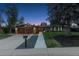 Inviting home exterior with well-manicured lawn, modern garage doors, and stylish landscaping at 7065 E Caley Ave, Centennial, CO 80111