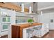 Modern kitchen featuring a breakfast bar, integrated appliances, stylish backsplash, and ample counter space at 7065 E Caley Ave, Centennial, CO 80111