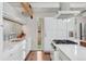 Bright kitchen features stainless steel appliances, sleek white cabinets and hardwood floors at 7065 E Caley Ave, Centennial, CO 80111