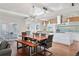 Open-concept living space featuring modern dining area, stylish lighting, and a bright kitchen, perfect for entertaining at 7065 E Caley Ave, Centennial, CO 80111