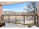 Balcony view overlooking city streets and neighboring buildings on a sunny day at 1301 Speer Blvd # 207, Denver, CO 80204