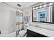 Bathroom featuring a shower-tub combination, toilet, vanity with black drawers, and a mirrored medicine cabinet at 1301 Speer Blvd # 207, Denver, CO 80204