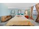 Comfortable bedroom featuring a decorative wallpaper accent wall and natural light at 1301 Speer Blvd # 207, Denver, CO 80204