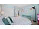 Comfortable bedroom featuring large windows, floral paintings, and a unique turquoise side table at 1301 Speer Blvd # 207, Denver, CO 80204