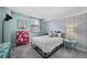 Bedroom featuring a stylish patterned wall and a colorful painted dresser, along with an adjacent view at 1301 Speer Blvd # 207, Denver, CO 80204