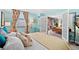 Bright bedroom with a window view, a comfortable bed, and adjacent living area through stylish French doors at 1301 Speer Blvd # 207, Denver, CO 80204