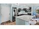 Modern kitchen features stainless steel appliances, dark cabinets, and a breakfast bar at 1301 Speer Blvd # 207, Denver, CO 80204