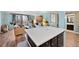 Open-concept kitchen flows into the living room with a mounted TV and cozy furniture at 1301 Speer Blvd # 207, Denver, CO 80204