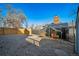 Gravel backyard with fencing, chicken coop and gate at 5404 W Rowland Pl, Littleton, CO 80128