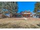 Spacious brick home with walkout basement and large, tiered deck overlooking the backyard at 5404 W Rowland Pl, Littleton, CO 80128