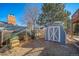 Fenced backyard featuring chicken coop and shed for outdoor storage needs at 5404 W Rowland Pl, Littleton, CO 80128