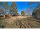 Expansive grassy backyard with brick home, deck, and mature trees at 5404 W Rowland Pl, Littleton, CO 80128