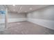 Finished basement with neutral carpet, white trim, and recessed lighting at 5404 W Rowland Pl, Littleton, CO 80128