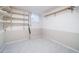 Unfinished basement area with tiled floor and shelving for storage at 5404 W Rowland Pl, Littleton, CO 80128