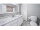 Bright bathroom with a marble countertop vanity, updated fixtures, and ample storage at 5404 W Rowland Pl, Littleton, CO 80128