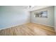 Bright and spacious bedroom with hardwood floors and a large window at 5404 W Rowland Pl, Littleton, CO 80128
