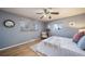 Serene bedroom with a ceiling fan, comfortable bed, and soft natural light from the windows at 5404 W Rowland Pl, Littleton, CO 80128