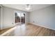 Sunlit bedroom boasts hardwood floors and sliding glass doors to a deck at 5404 W Rowland Pl, Littleton, CO 80128