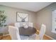Cozy dining area with hardwood floors, modern table set, and an art piece at 5404 W Rowland Pl, Littleton, CO 80128