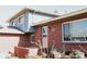 Charming brick home featuring a small manicured flower garden in front of the entrance at 5404 W Rowland Pl, Littleton, CO 80128
