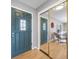 Welcoming entryway with modern decor and a mirrored closet, leading into the living space at 5404 W Rowland Pl, Littleton, CO 80128